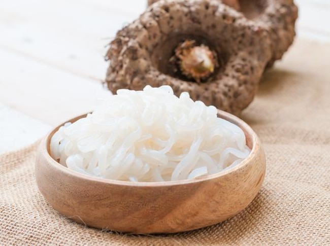 small portion of spaghetti mixed with minced meat served on white plate