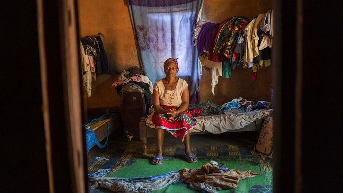 Vanessa Emedy waits for customers at the Virunga Market in Goma, Democratic Republic of the Congo, Tuesday March 29, 2022. On the night of her late husband Godefroid Kamana's burial, extended family members came to the family home where Vanessa had just begun her period of mourning. 