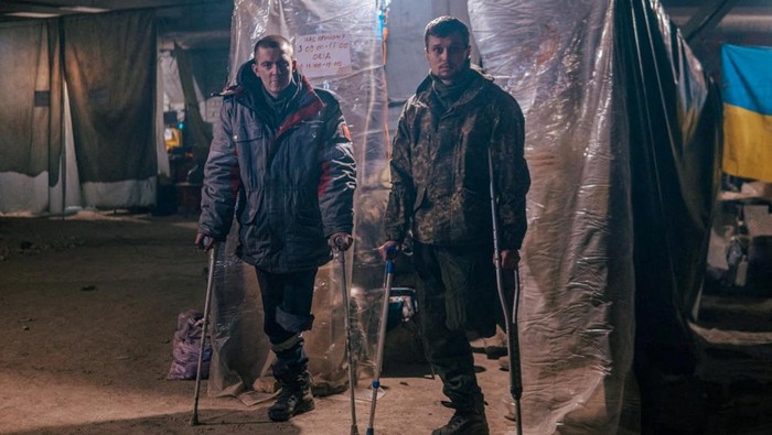 Injured Ukrainian service members use crutches at a field hospital inside a bunker of the Azovstal Iron and Steel Works in Mariupol, Ukraine, in this handout picture released May 10, 2022. Dmytro Orest Kozatskyi/Press service of Azov Regiment/Handout via REUTERS THIS IMAGE HAS BEEN SUPPLIED BY A THIRD PARTY. MANDATORY CREDIT     TPX IMAGES OF THE DAY