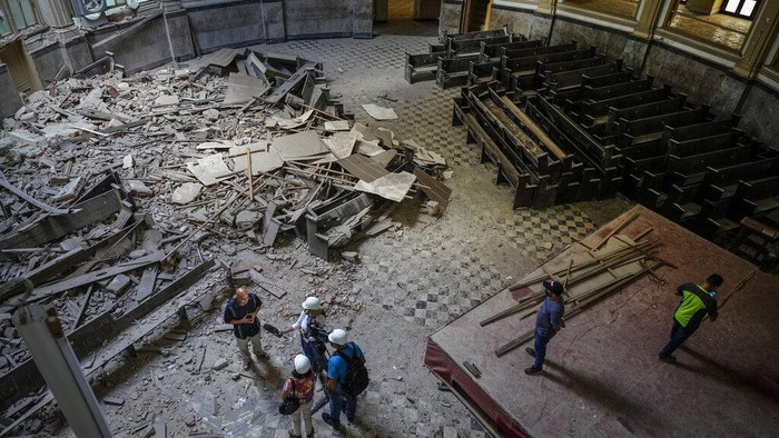 Church administrator Alejandro Clemente Gonzalez poses for a photo inside the Calvary Baptist Church damaged by an explosion that devastated the Hotel Saratoga which is located next door, in Old Havana, Cuba, Wednesday, May 11, 2022. Gonzalez was talking with an electrician while preparing for weekend services inside the church when the May 6 explosion shook the building and shattered the 19th century dome towering far above the pews. “I didn't know what was happening,