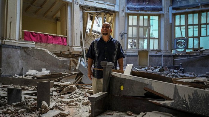 Church administrator Alejandro Clemente Gonzalez poses for a photo inside the Calvary Baptist Church damaged by an explosion that devastated the Hotel Saratoga which is located next door, in Old Havana, Cuba, Wednesday, May 11, 2022. Gonzalez was talking with an electrician while preparing for weekend services inside the church when the May 6 explosion shook the building and shattered the 19th century dome towering far above the pews. “I didn't know what was happening,