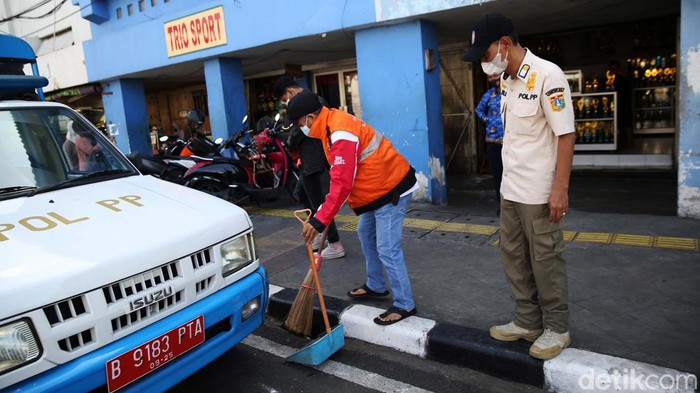 Jakarta PPKM Level 2, Razia Masker Terus Dilakukan Petugas Satpol PP melakukan razia masker di depan Pasar Jatinegara Jakarta, Jumat (13/5/2022). Perpanjangan masa PPKM di Jakarta diperpanjang hingga 23 Mei 2022. Anies juga sudah menerbitkan Keputusan Gubernur Nomor 447 Tahun 2022 tentang Pemberlakuan Pembatasan Kegiatan Masyarakat Level 2 Corona Virus Disease 2019.