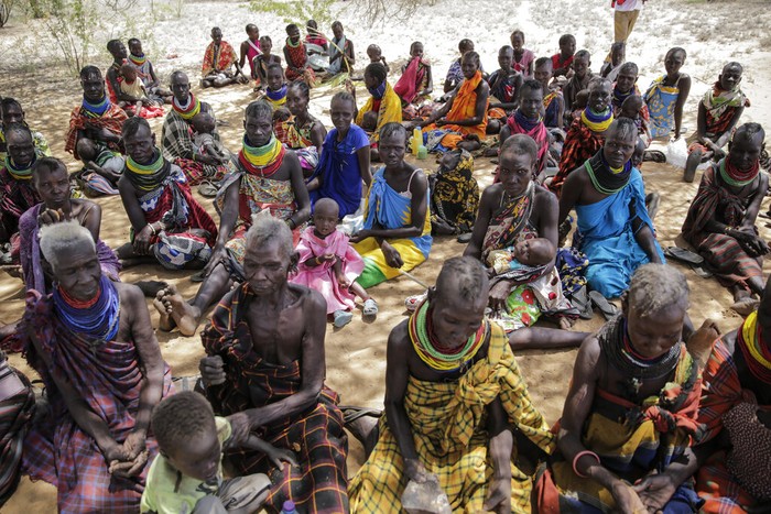 Villagers walk back from a trading center towards their village of Lomoputh in northern Kenya Thursday, May 12, 2022. United Nations Under-Secretary-General for Humanitarian Affairs Martin Griffiths visited the area on Thursday to see the effects of the drought which the U.N. says is a severe climate-induced humanitarian emergency in the Horn of Africa. (AP Photo/Brian Inganga)