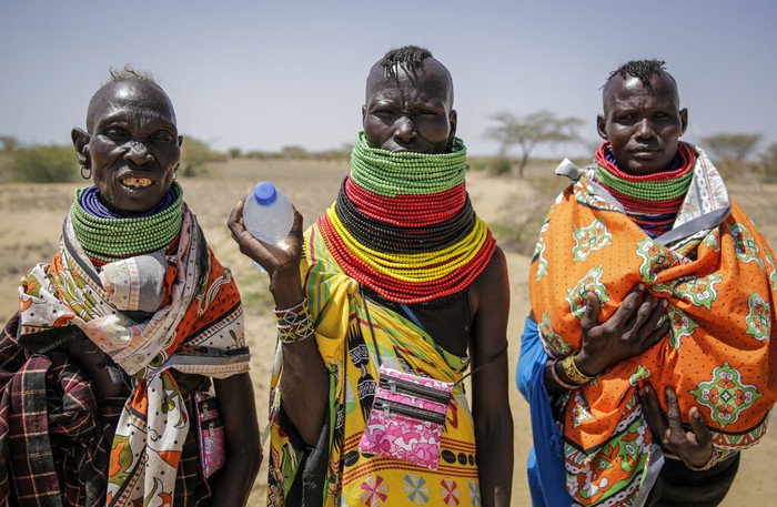 Villagers walk back from a trading center towards their village of Lomoputh in northern Kenya Thursday, May 12, 2022. United Nations Under-Secretary-General for Humanitarian Affairs Martin Griffiths visited the area on Thursday to see the effects of the drought which the U.N. says is a severe climate-induced humanitarian emergency in the Horn of Africa. (AP Photo/Brian Inganga)