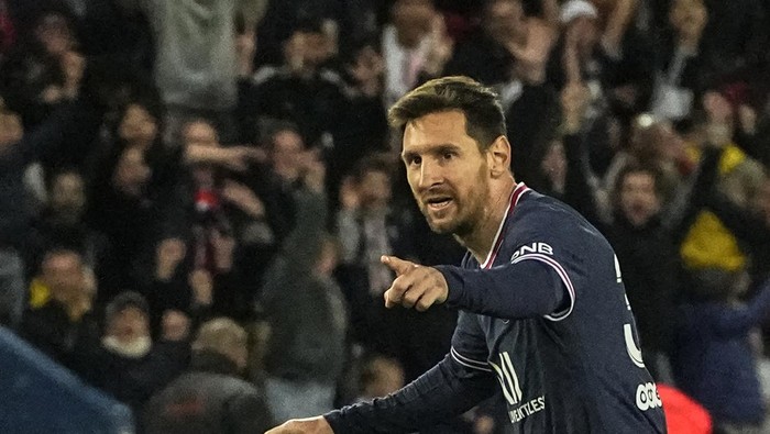 PSGs Lionel Messi celebrates after scoring the opening goal during the French League One soccer match between Paris Saint Germain and Lens at Parc des Princes stadium in Paris, Saturday, April 23, 2022. (AP Photo/Michel Euler)