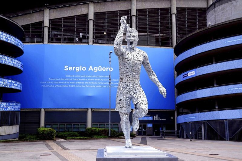 A statue of Manchester City Club legend, Argentinian Sergio Aguero, designed by sculptor Andy Scott is unveiled outside the Etihad Stadium, to commemorate the tenth anniversary of the Club's first Premier League title and the iconic '93:20' moment in Manchester, England, Friday May 13, 2022. (Martin Rickett/PA via AP)