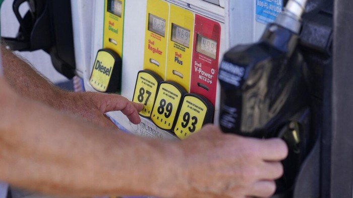 A customer pumps gas at a Shell gas station, Tuesday, May 10, 2022, in Miami. (AP Photo/Marta Lavandier)