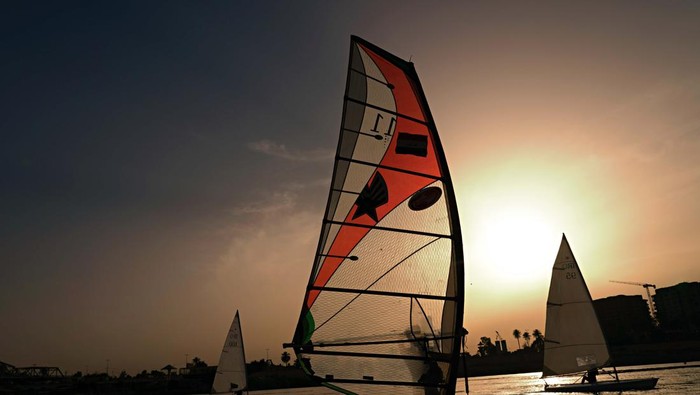 Members of the Iraqi national windsurfing team train in the Tigris River for the Arab. sailing Championships in Baghdad, Iraq, Saturday, May 14, 2022. (AP Photo/Hadi Mizban)