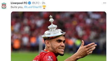 Momen pemain Liverpool, Luis Diaz memakai tutup piala sebagai topi di postingan resmi Liverpool FC. Foto: (Twitter)