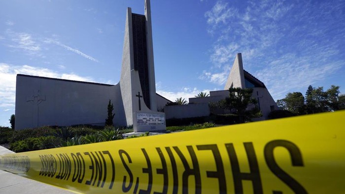 Crime scene tape is stretched across an area at Geneva Presbyterian Church in Laguna Woods, Calif., Sunday, May 15, 2022, after a fatal shooting. (AP Photo/Damian Dovarganes)