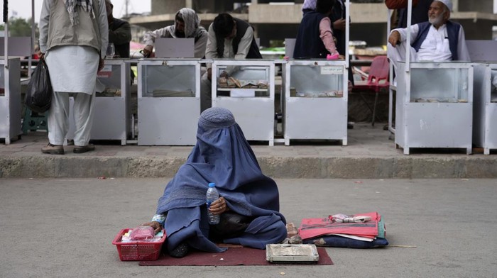 An Afghan woman vendor waits for customers at the old market in Kabul, Afghanistan, Sunday, May 15, 2022. (AP Photo/Ebrahim Noroozi)