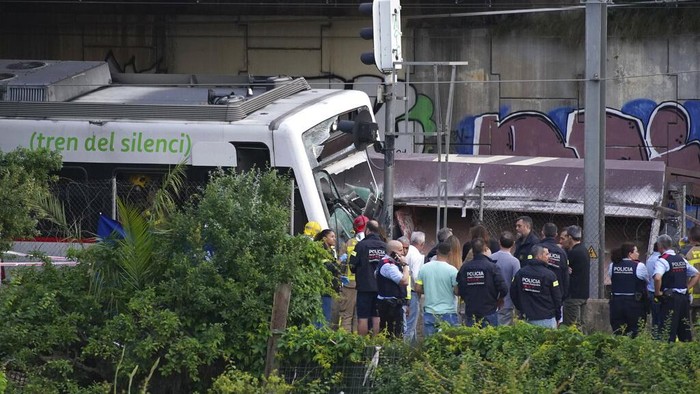 A passenger is helped by medics after a train crash in Sant Boi near Barcelona, Spain, Monday, May 16, 2022. A goods train smashed into a rush-hour passenger train in Catalonia, killing an engineer and injuring 85 people as it came into the Sant Boi station near Barcelona, crashing into the front of the passenger train that was pulling out of the station. Catalan emergency services said crews were helping to evacuate the about 100 people on board the passenger train. (AP Photo/Joan Mateu Para)