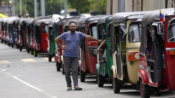 A man participates in a protest outside a police station demanding petrol in Colombo, Sri Lanka, Saturday, May 14, 2022. Sri Lankans have been forced to wait in long lines to purchase scarce imported essentials such as medicines, fuel, cooking gas and food because of a severe foreign currency shortage. (AP Photo/Eranga Jayawardena)