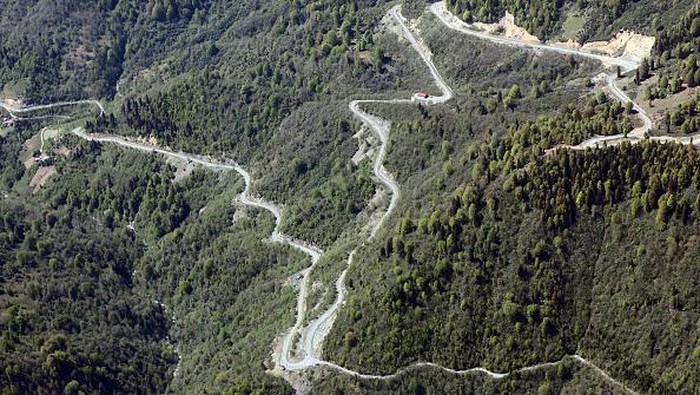 ERZURUM, TURKIYE - MAY 18: An aerial view of winding roads of in the steep mountains of the Eastern Black Sea region in Erzurum, located near the border lines of Artvin, Turkiye on May 18, 2022. The roads opened as a result of hard work in wooded and rocky areas in Savsat, Borcka and Hopa districts of Artvin reveal the difficulty of transportation in the mountainous lands of the region. (Photo by Huseyin Yildiz/Anadolu Agency via Getty Images)