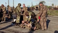Sebuah gambar yang diambil dari video yang dirilis oleh Kementerian Pertahanan Rusia menunjukkan apa yang diklaim Moskow sebagai prajurit Ukraina sedang digeledah oleh mililter pro-Rusia saat akan meninggalkan pabrik baja Azovstal di Mariupol, Ukraina. Untuk diketahui, video ini dirilis pada Selasa (17/5/2022) waktu setempat. (Russian Defence Ministry/Handout via REUTERS).