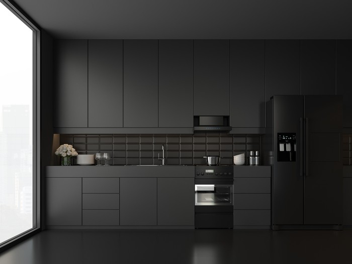 Minimal style black kitchen 3d render.There are white floor and wall, Glossy white cabinet doors,Black refrigerator and oven,The room has large windows. lookink out to the city view.