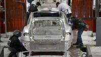 Selanjutnya, proses perakitan dibantu oleh pekerja manusia. Foto: AP/Jeff Chiu