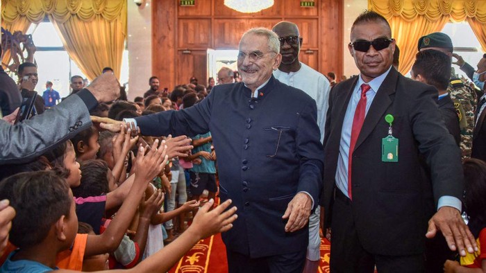 East Timor's President Jose Ramos Horta (C) greets children before a flag raising ceremony in Dili on May 20, 2022, to commemorate the 20th anniversary of East Timor's independence from Indonesia. (Photo by VALENTINO DARIEL SOUSA / AFP) (Photo by VALENTINO DARIEL SOUSA/AFP via Getty Images)
