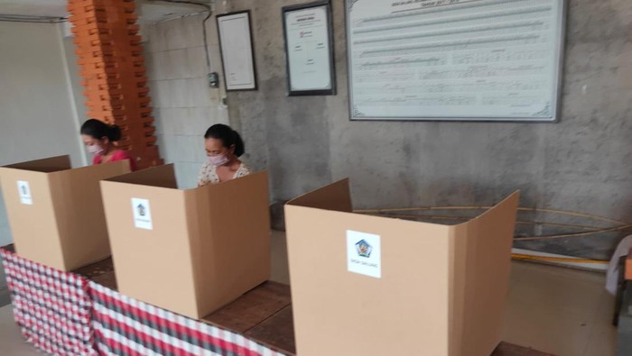 Warga di Desa Adat Dalung melakukan pencoblosan di TPS 13, Banjar Kung, Desa Adat Dalung Minggu (22/05/2022)