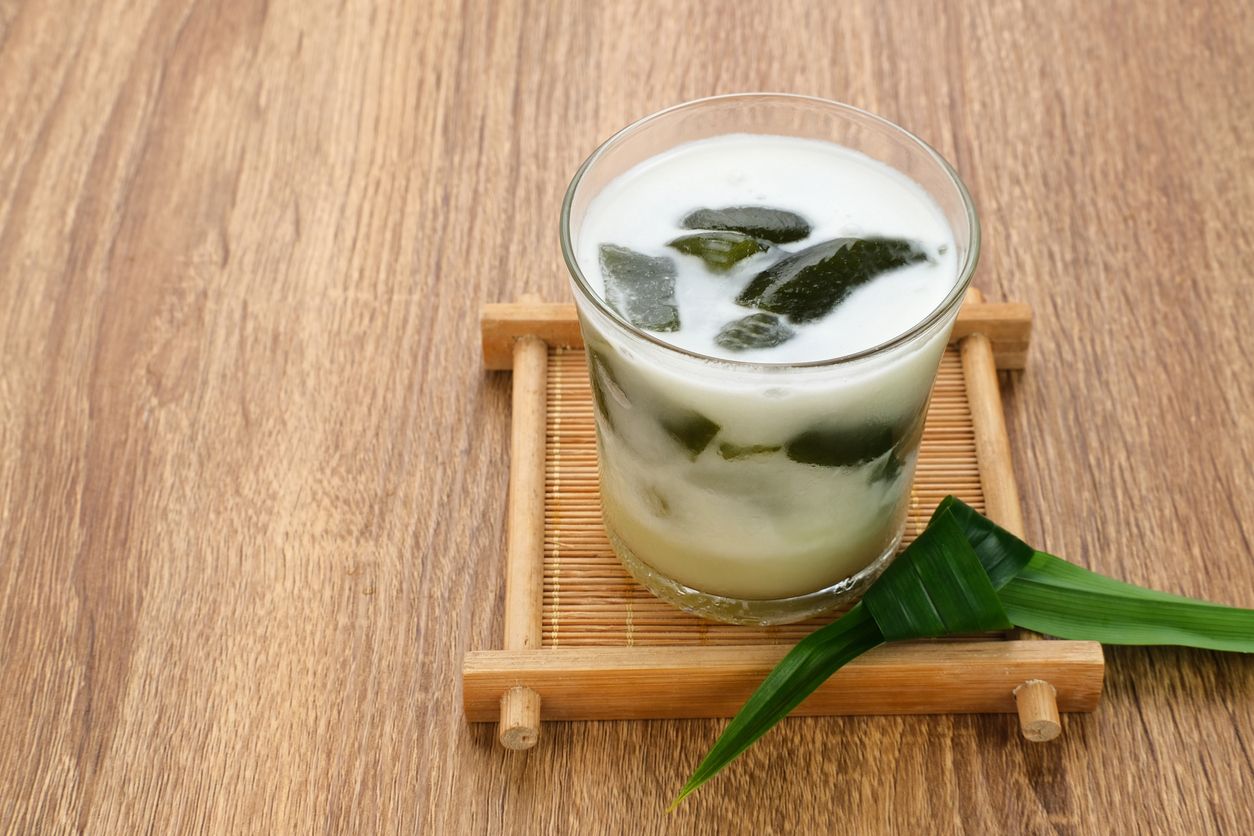 Es Cincau Hijau (green grass jelly), a traditional Indonesian dessert. Made from cincau, coconut milk and palm sugar. Selected focus.
