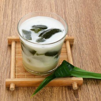 Es Cincau Hijau (green grass jelly), a traditional Indonesian dessert. Made from cincau, coconut milk and palm sugar. Selected focus.