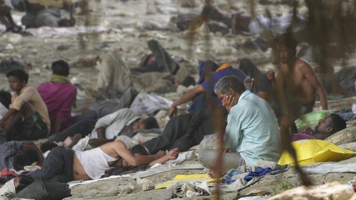 Homeless people sleep in the shade of an overbridge on a hot day in New Delhi, Friday, May 20, 2022. The Indian capital and surrounding areas are facing extreme heat wave conditions. (AP Photo/Manish Swarup)