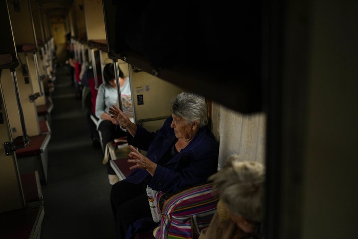 Russia Ukraine War Lyubov Chudnyk, right, fleeing from heavy shelling, waits aboard an evacuation train to depart Pokrovsk train station, in Pokrovsk, eastern Ukraine, Sunday, May 22, 2022. Civilians fleeing areas near the eastern front in the war in Ukraine Sunday described scenes of devastation as their towns and villages came under sustained attack from Russian forces. (AP Photo/Francisco Seco)