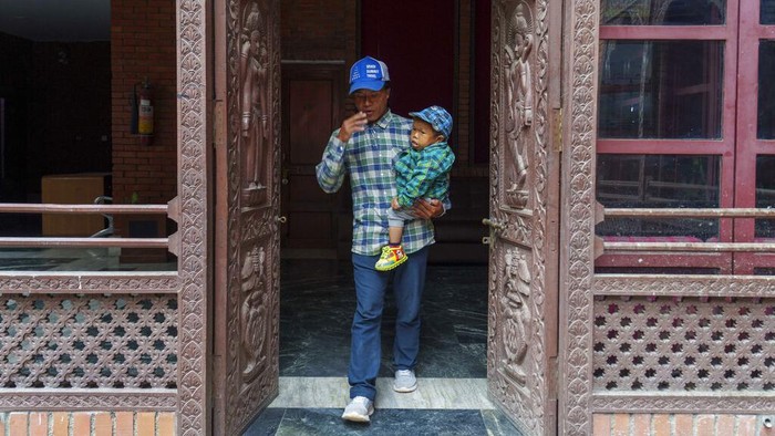 Dor Bahadur Khapangi holds his Guinness World Record certificate in Kathmandu, Nepal, Tuesday, May 24, 2022. Khapangi holds the record as the world's shortest teenager (living), measuring 73.43 cm (2ft 4.9 inches). (AP Photo/Niranjan Shrestha)