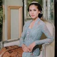 Kali ini ia terlihat memakai kebaya biru, batik, hair piece juga paes yang dirias tipis. Foto: Instagram @maudyayunda