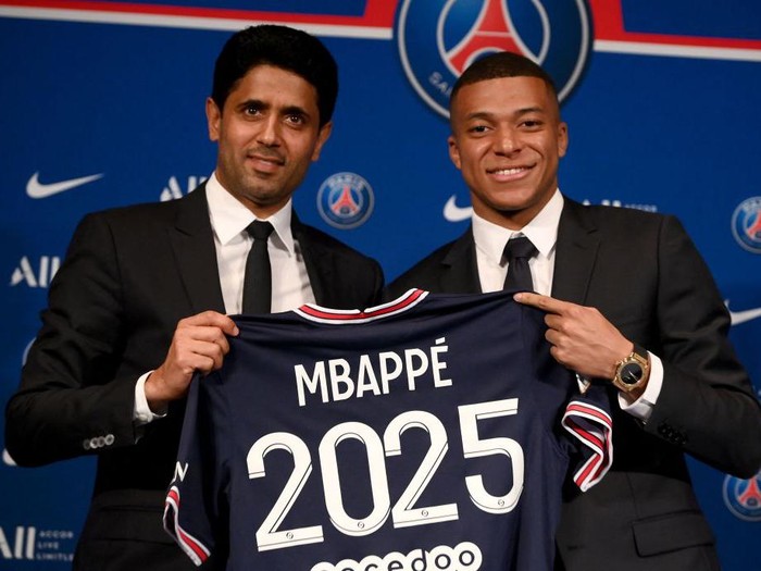 Paris Saint-Germain's French forward Kylian Mbappe poses with a jersey at the end of a press conference at the Parc des Princes stadium in Paris on May 23, 2022, two days after the club won the Ligue 1 title for a record-equalling tenth time and its superstar striker Mbappe chose to sign a new contract until 2025 at PSG rather than join Real Madrid. (Photo by FRANCK FIFE / AFP) (Photo by FRANCK FIFE/AFP via Getty Images)
