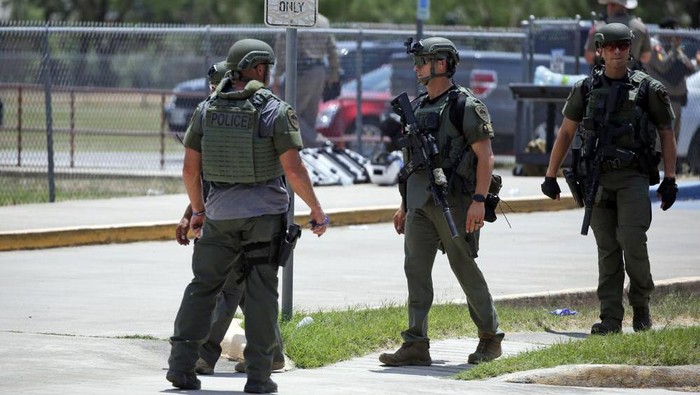 Law enforcement personnel stand outside Robb Elementary School following a shooting, Tuesday, May 24, 2022, in Uvalde, Texas. (AP Photo/Dario Lopez-Mills)