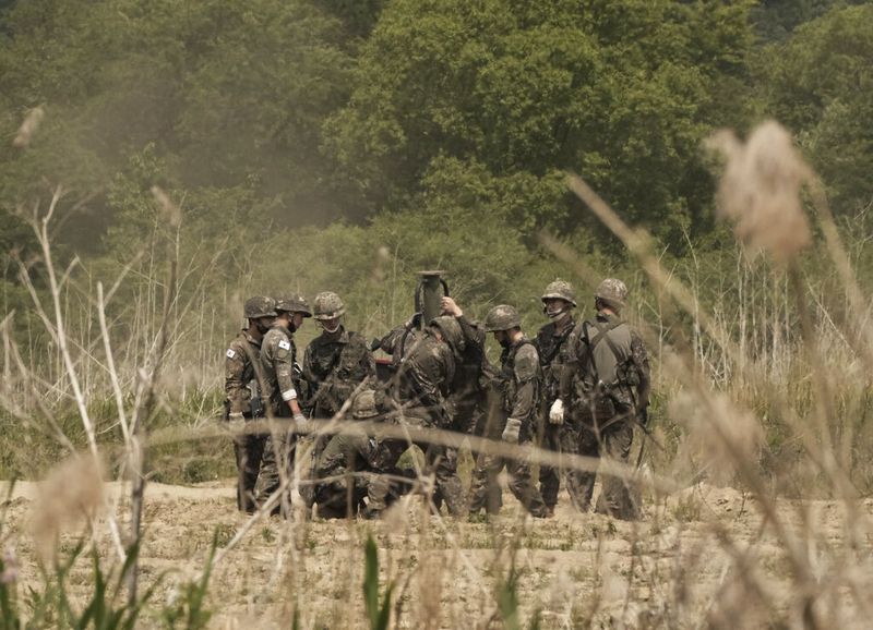 South Korean army soldiers work in Yeoncheon, near the border with North Korea, South Korea, Wednesday, May 25, 2022. North Korea test-launched a suspected intercontinental ballistic missile and two shorter-range weapons into the sea Wednesday, South Korea said, hours after President Joe Biden ended a trip to Asia where he reaffirmed the U.S. commitment to defend its allies in the face of the North's nuclear threat. (AP Photo/Ahn Young-joon)