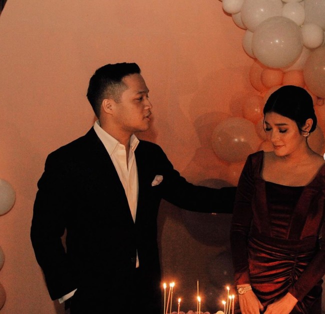 Dekorasi di pesta kejutan ulang tahun Naysilla itu tampak simpel dengan dihiasi balon berwarna putih dan oranye. Di dalam foto tampak Naysilla yang sedang mengucap permohonan sebelum meniup lilin di kue ulang tahunnya. Foto: Instagram/@naymirdad