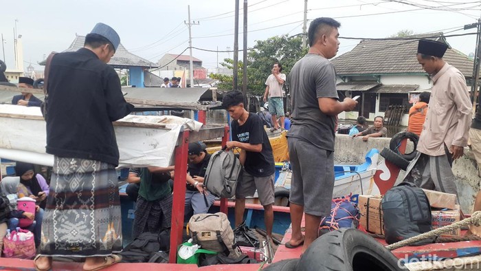 Calon penumpang kapal harus naik perahu menuju Pelabuhan Tanjung Emas Semarang lantaran akses jalan tertutup banjir, Rabu (25/5/2022).