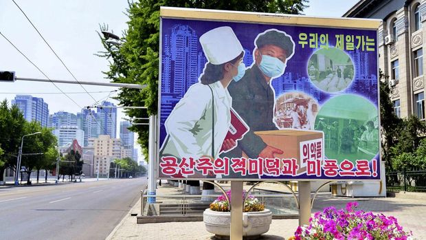A sign depicting a scene of medical products transportation is displayed at the empty street, amid growing fears over the spread of coronavirus disease (COVID-19), in Pyongyang, North Korea, in this photo released by Kyodo on May 23, 2022. Kyodo via REUTERS ATTENTION EDITORS - THIS IMAGE WAS PROVIDED BY A THIRD PARTY. MANDATORY CREDIT. JAPAN OUT. NO COMMERCIAL OR EDITORIAL SALES IN JAPAN.