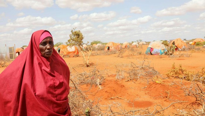 Ibu Ini Kehilangan Putri Kembarnya Gegara Kelaparan Halima Hassan Abdullahi stands near the graves of her twin granddaughters Ebla and Abdia, who died of hunger at the Kaxareey camp for the internally displaced people, in Dollow, Gedo region of Somalia May 24, 2022. Picture taken May 24, 2022. REUTERS/Feisal Omar