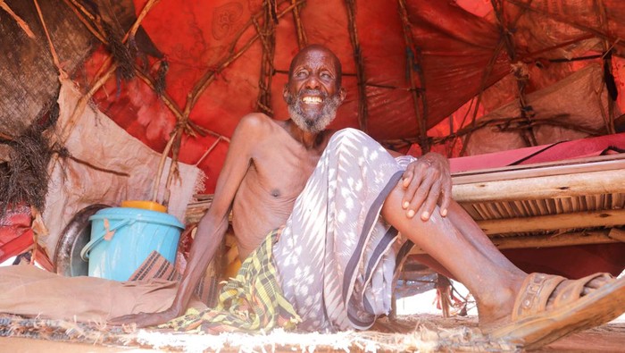 Amina Hassan Aden sits with her children Yonis Saleban, 1, Abdulahi Saleban, 3, and Isnino Saleban, 9, inside their makeshift shelter at the Kaxareey camp for the internally displaced people in Dollow, Gedo region of Somalia May 24, 2022. Picture taken May 24, 2022. REUTERS/Feisal Omar