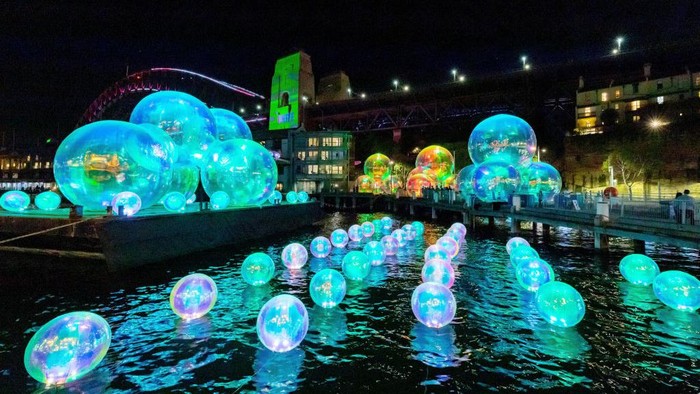 1399555529 SYDNEY, AUSTRALIA - MAY 27: Light installations near the Sydney Harbour Bridge for the opening of the Vivid Sydney festival on May 27, 2022 in Sydney, Australia. The annual Vivid Sydney festival has officially started, transforming the famous Harbour City into an illuminating fusion of creativity, innovation and technology. Celebrating the essence of Sydney, including its First Nations culture, diversity, beauty, resilience, and vibrant creative community, more than 200 events will be staged throughout Sydney and its surrounds during what is Australia's largest event from Friday 27 May to Saturday 18 June. Highlights of the 23-day festival include an 8-kilometre continuous Light Walk stretching from Sydney Opera House to Central Station and the Southern Hemisphere's largest-ever drone show from Paramount+. (Photo by James D. Morgan/Getty Images for Destination New South Wales)