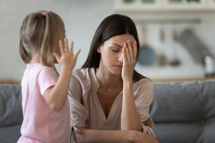 Tired single mother feel stressed desperate about screaming stubborn kid daughter tantrum, frustrated depressed young adult mom annoyed by naughty difficult rebellious child girl problems concept