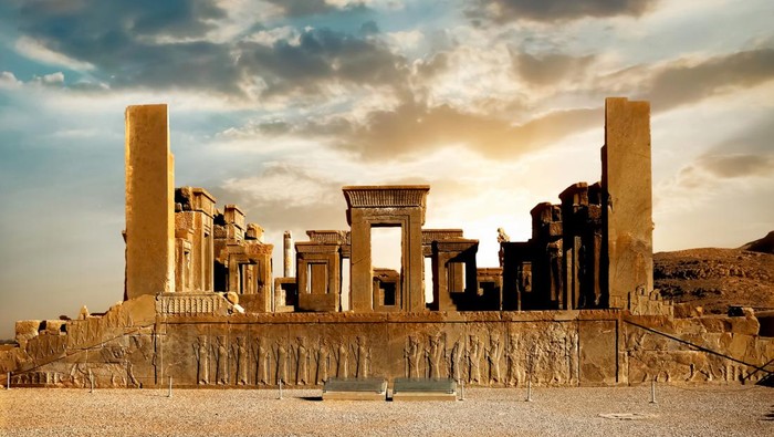 Sunrise in Persepolis, capital of the ancient Achaemenid kingdom. Ancient columns. Sight of Iran. Ancient Persia. Beautiful sunrise background.
