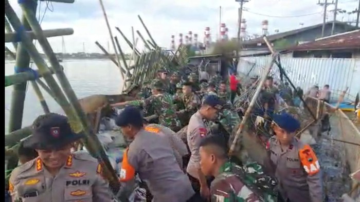 Anggota TNI dan Polri memperbaiki tanggul jebol di Pelabuhan Semarang, Jumat (27/5/2022).