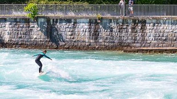 Thun, Switzerland, A surfer performing near the Old Lock of the Aare river. (Photo by: Masci Giuseppe/AGF/Universal Images Group via Getty Images)
