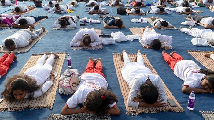 People participate in a mass yoga session at Lal Bahadur Shastri Stadium in Hyderabad on May  27, 2022. (Photo by Noah SEELAM / AFP) (Photo by NOAH SEELAM/AFP via Getty Images)