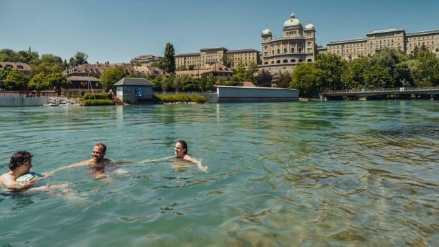The cathedral of Bern or Munster along side of Aare river in sunny day, Switzerland tourism