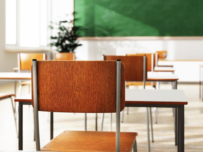 Closeup student chair back seat and desk in classroom background with on wooden floor. Education and Back to school concept. Architecture interior. Social distancing theme. 3D illustration rendering