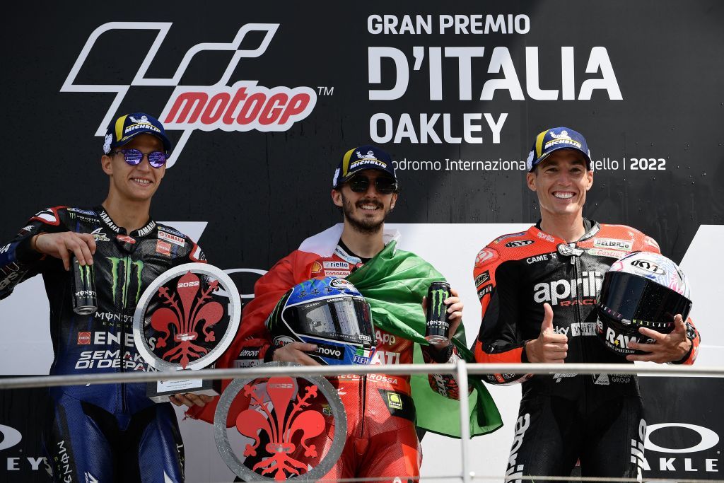 (From L) Second-placed Monster Energy Yamaha's French rider Fabio Quartararo, race winner Ducati Lenovo Team Italian rider Francesco Bagnaia and third-placed Aprilia Racing Spanish rider Aleix Espargaro celebrate on the podium after the Italian Moto GP Grand Prix at the Mugello race track, Tuscany, on May 29, 2022. (Photo by Filippo MONTEFORTE / AFP) (Photo by FILIPPO MONTEFORTE/AFP via Getty Images)