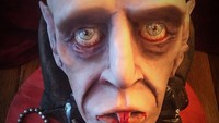 Kepala monster dengan mata yang menerawang ke atas, dan gigi taring yang berdarah. Membuat orang yang akan memotong kuenya, menjadi segan. Foto: Pool/Site