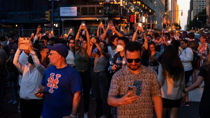 NEW YORK, NY - JULY 4: A view of the 'Manhattanhenge' sunset as people are gathered in Long Island City to watch Macyâs 4th of July Fireworks in New York City, United States on July 4, 2021. (Photo by Tayfun Coskun/Anadolu Agency via Getty Images)