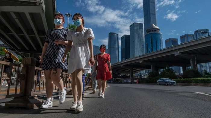 BEIJING, CHINA -MAY 30: Office workers wait in line to show their health codes and proof of 48 hour negative nucleic acid test, outside an office building after some people returned to work, in the Central Business District on May 30, 2022 in Beijing, China. China is trying to contain a spike in coronavirus cases in Beijing after hundreds of people tested positive for the virus in recent weeks. Local authorities have initiated mass testing, mandated proof of a negative PCR test within 48 hours to enter many public spaces, closed schools and  banned gatherings and inside dining in all restaurants, and locked down many neighborhoods in an effort to maintain the countrys zero COVID strategy. Due to improved control and lower numbers of new cases and reduced spread, municipal officials from Sunday permitted the easing of some restrictions to allow for limited return to office, resumption of public transport, and the re-opening of many shopping malls, parks, and scenic spots with limited capacity in some districts. (Photo by Kevin Frayer/Getty Images)
