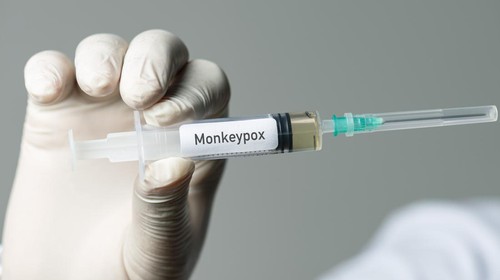 Male doctor holding monkeypox vaccine.